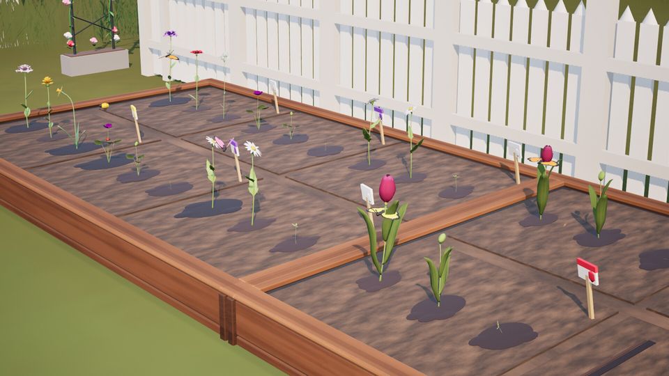 A raised garden bed with tulips and daisies